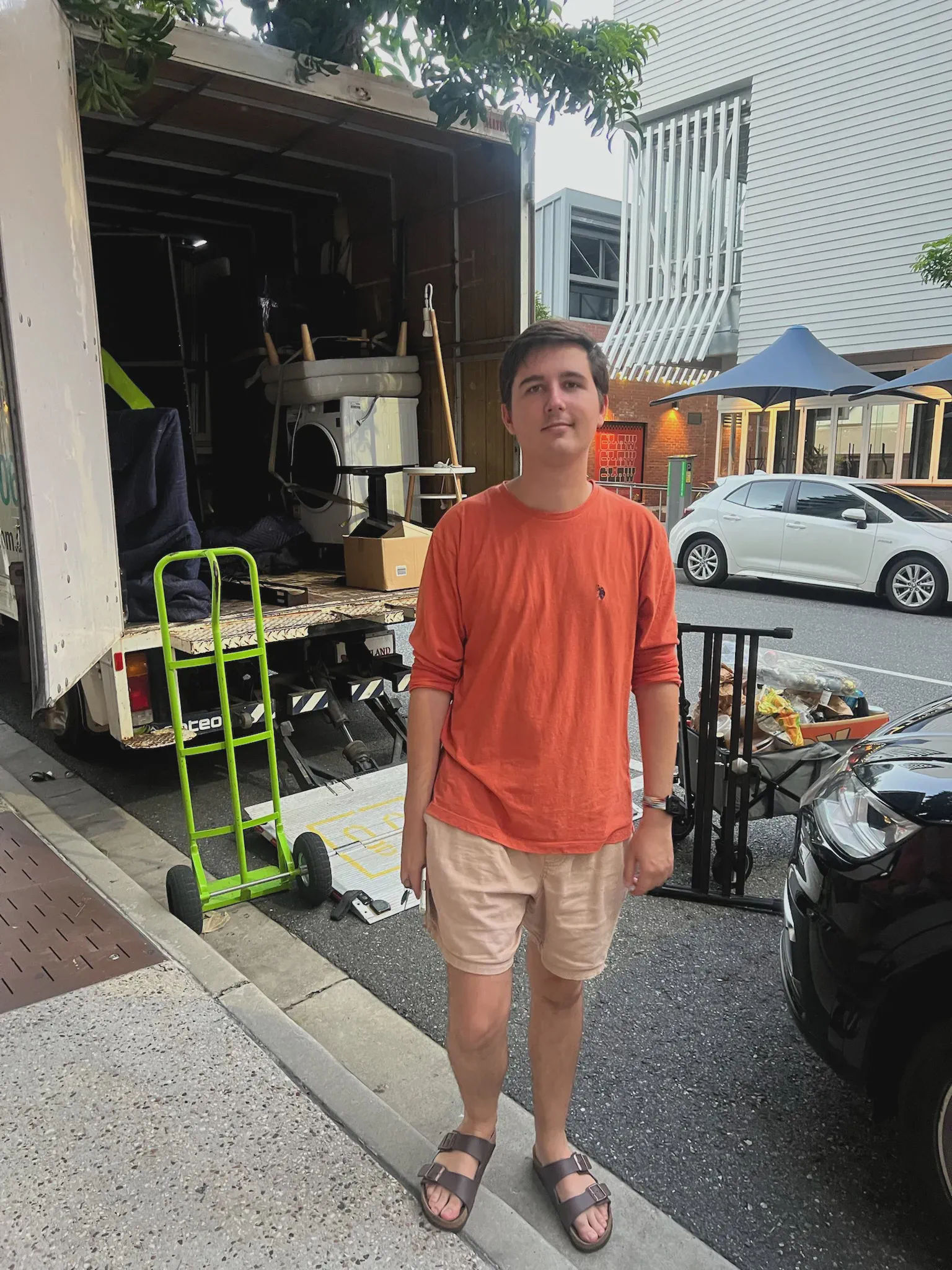 Ed standing behind the moving truck, King St